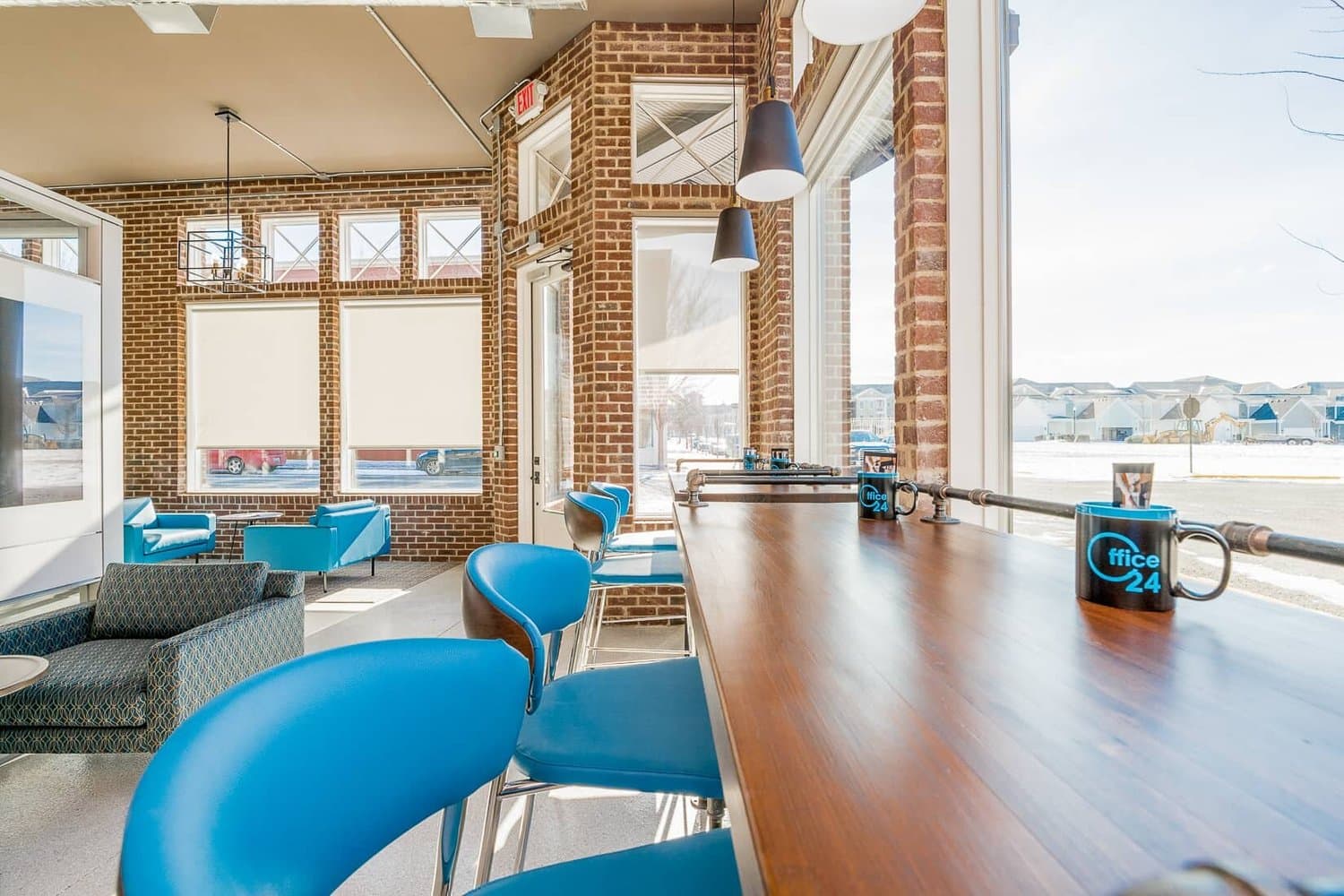 Counter seating with blue stools along the windows