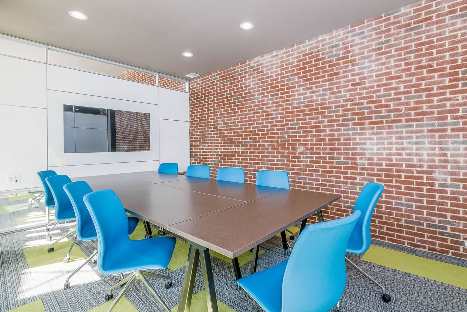 Conference table seen from the doorway with brick wall behind