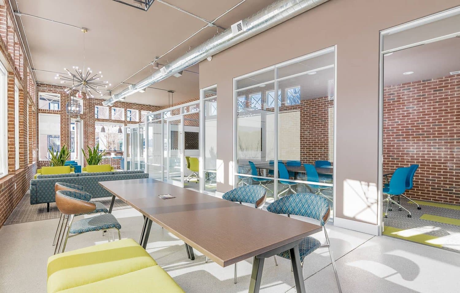 Row of glass-walled offices off the main lounge