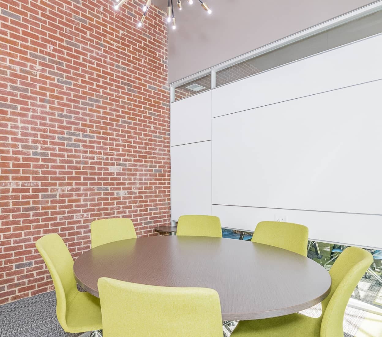 Round meeting table with lime green chairs