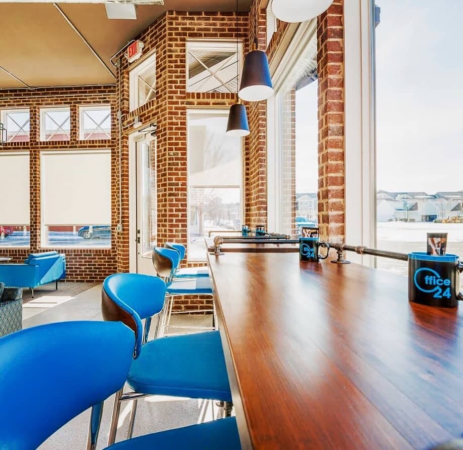Window bar seating with blue chairs overlooking Norton Commons